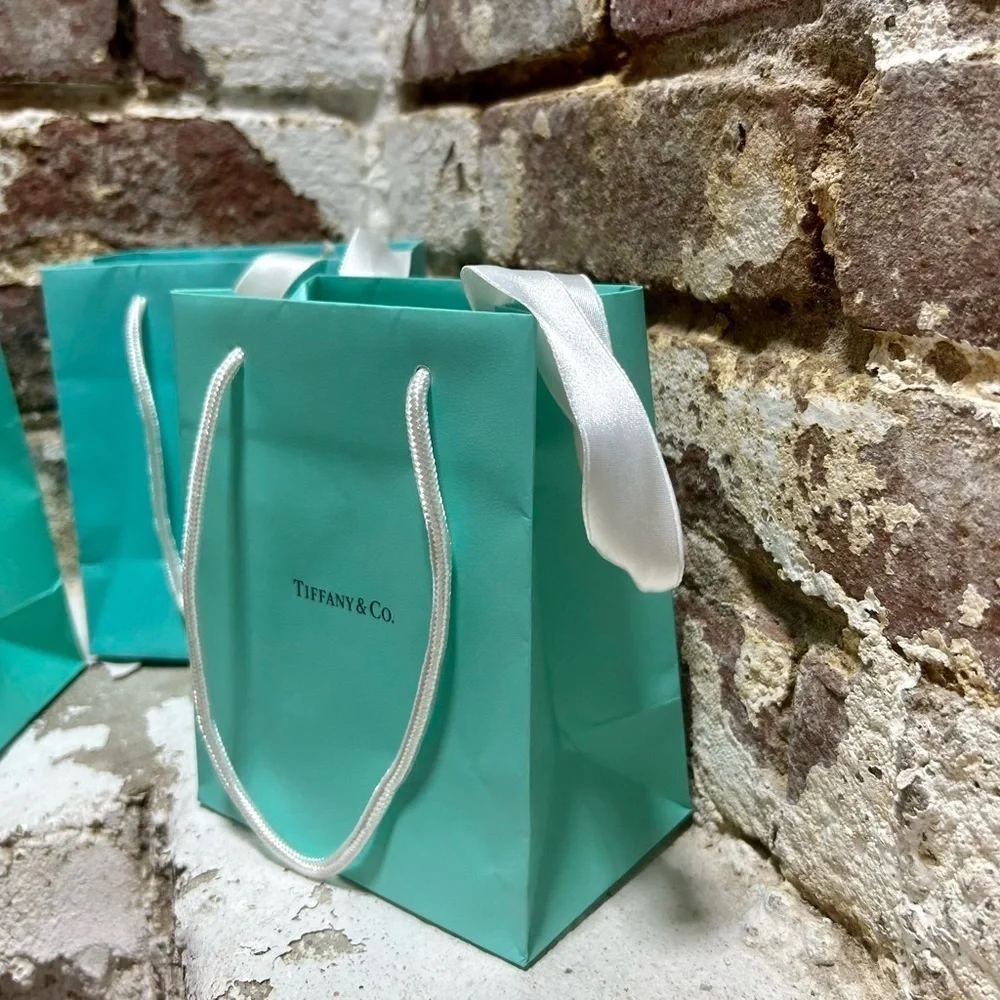 Set of three original Tiffany & Co blue bags and white ribbons.